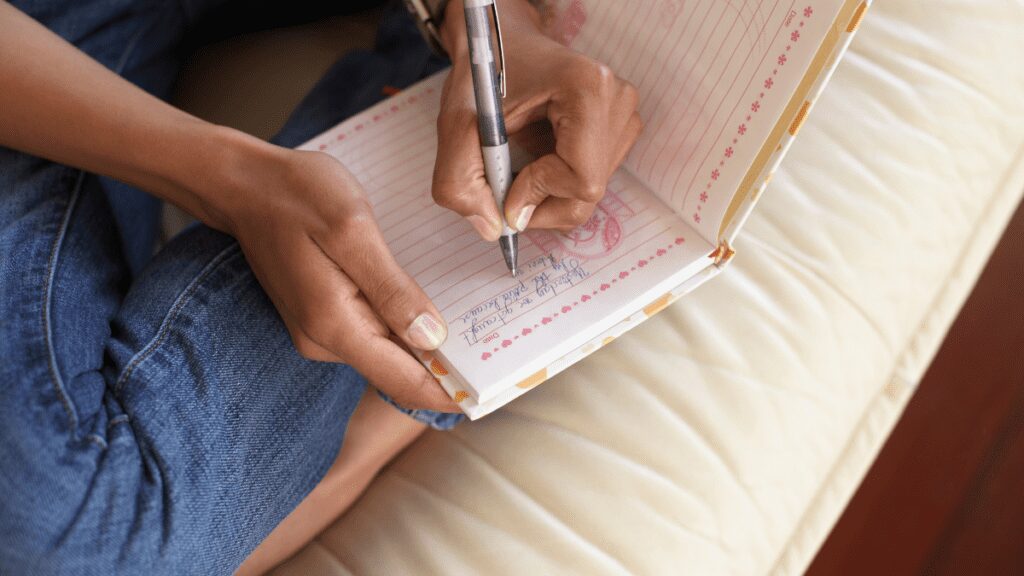 A woman writing in her journal before bed