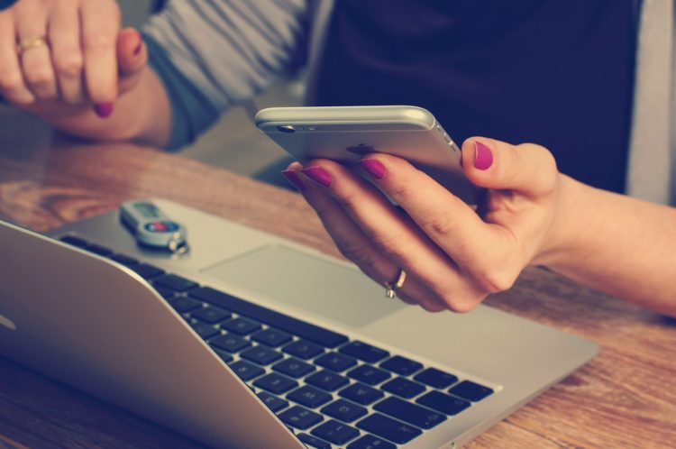 A woman on her phone, becoming more mindfully aware of her phone use